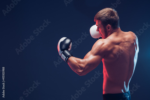 shirtless boxer with gloves on dark background. Isolate © zamuruev