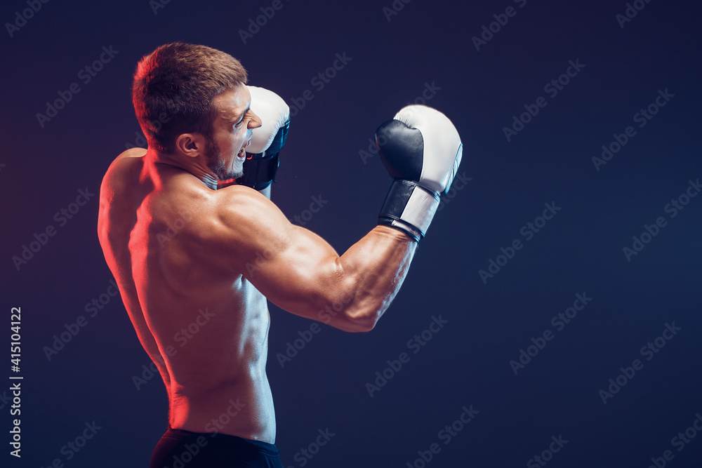 shirtless boxer with gloves on dark background. Isolate shirtless boxer with gloves on dark background. Isolate