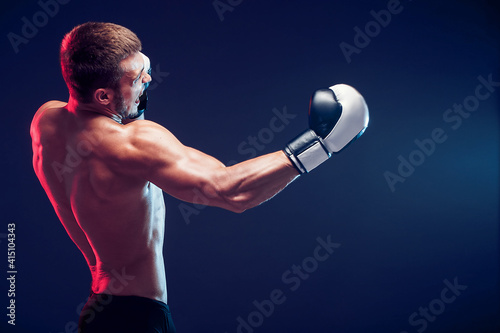 shirtless boxer with gloves on dark background. Isolate © zamuruev