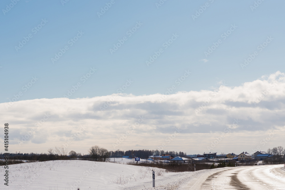 Winter road under blue sky.Rural road asphalt.