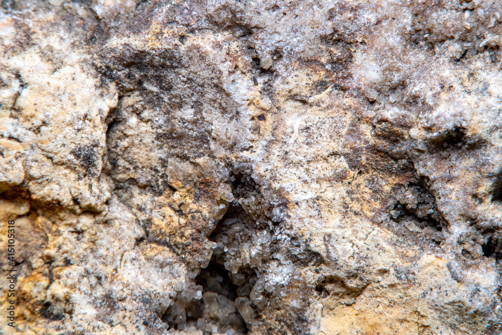 Stone surface texture at high magnification with numerous microscopic formations of natural quartz crystals in cracks