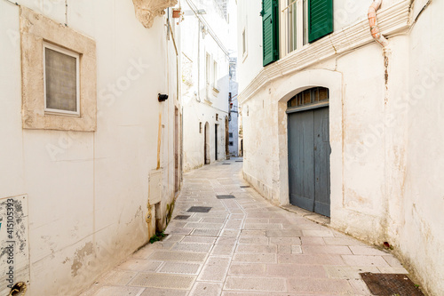 Italy  Apulia  Province of Taranto  Martina Franca. Narrow  curving street lined with white stucco buildings.