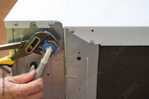 Handyman repairs dishwasher