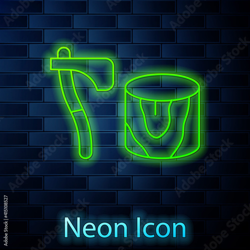 Glowing neon line Wooden axe in stump icon isolated on brick wall background. Lumberjack axe. Axe stuck in wood. Chopping wood. Vector.