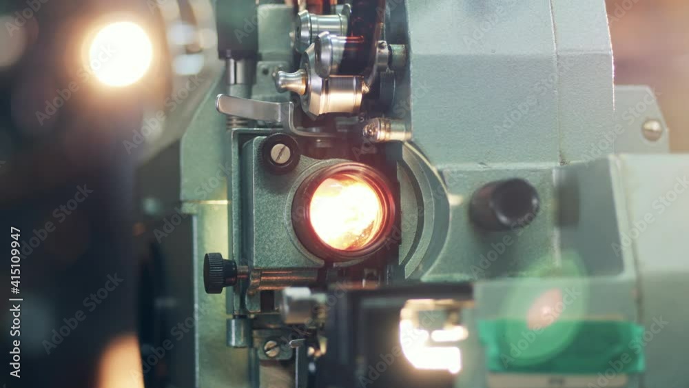 Close up of a vintage film projector showing a tape movie. Retro film, vintage technology concept.