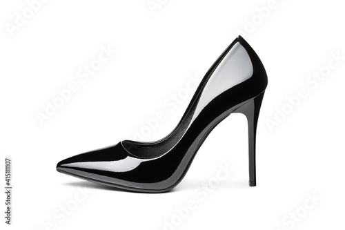 One black lacquered shiny female shoes with thin high heels isolated on white background. Close-up