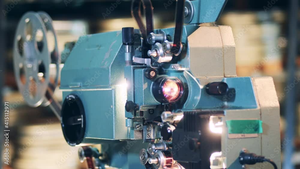 Working old film projector in a detailed view. Vintage movie, old cinema concept. Working old film projector in a detailed view. Vintage movie, old cinema concept.