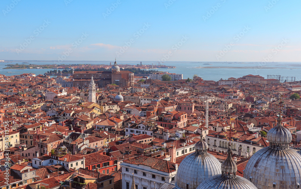 A panoramic bird's eye view of the islands, roofs, bell towers, cathedrals of ancient Venice in the early morning