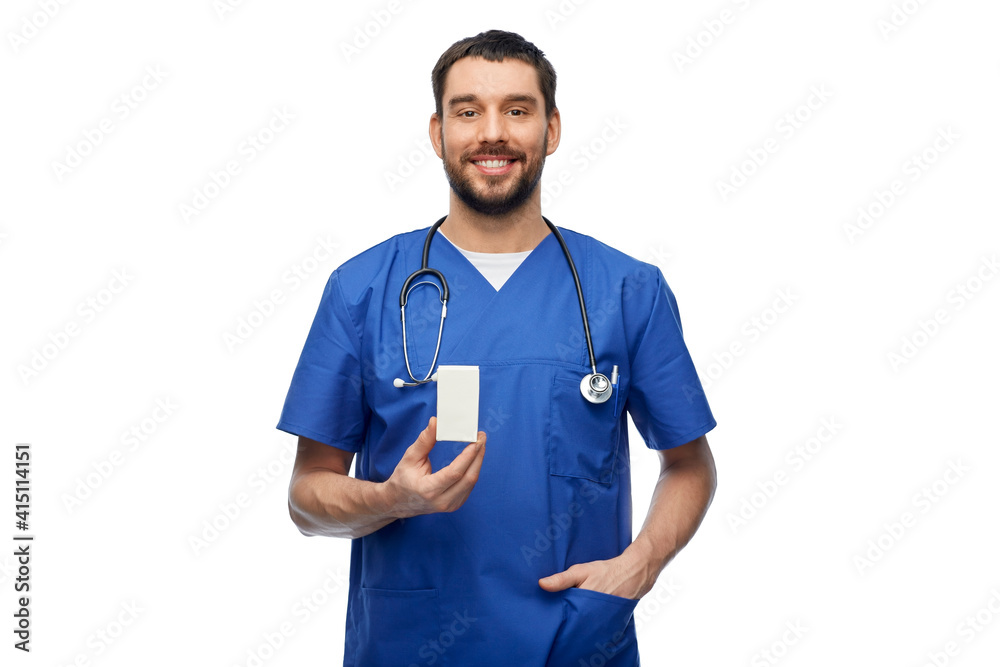 healthcare, profession and medicine concept - doctor or male nurse in blue uniform with box of pills and stethoscope over white background healthcare, profession and medicine concept - doctor or male nurse in blue uniform with box of pills and stethoscope over white background