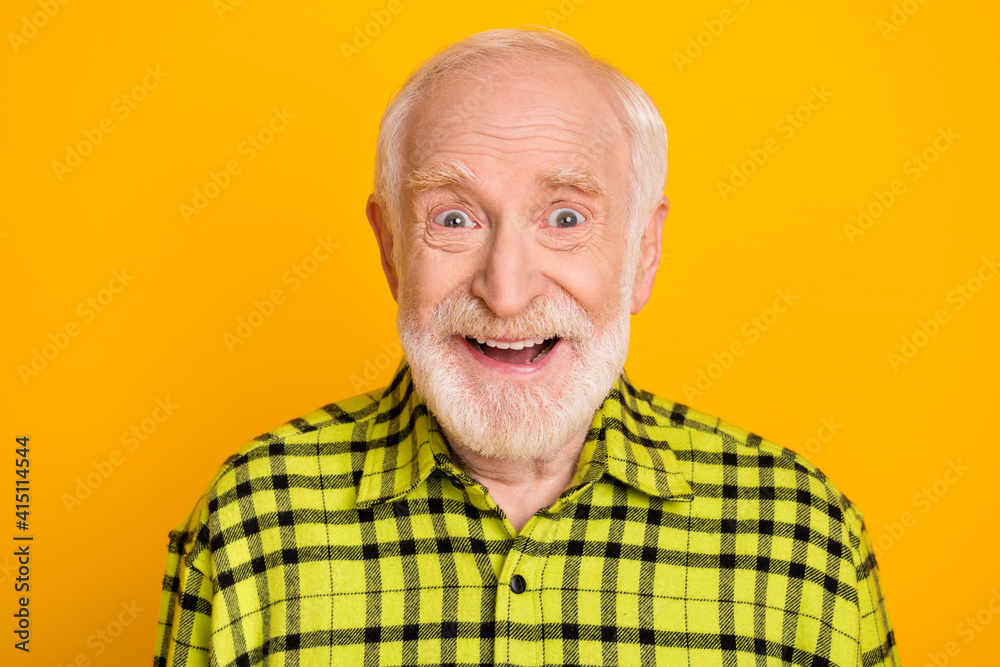 Photo of excited aged man happy positive smile amazed shocked surprised news isolated over yellow color background Photo of excited aged man happy positive smile amazed shocked surprised news isolated over yellow color background