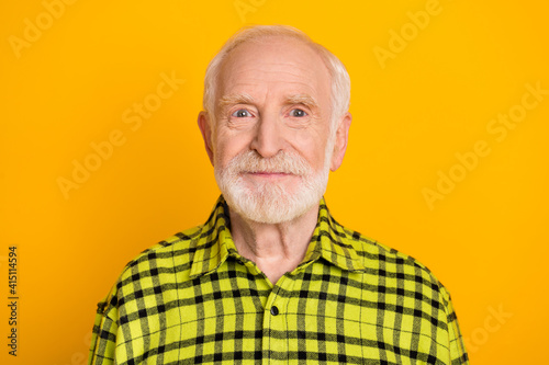 Photo of aged man pensioner happy positive smile wear casual shirt isolated over yellow color background