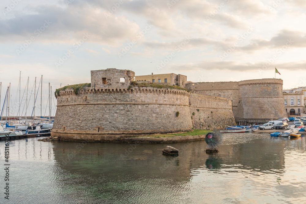 Italy, Apulia, Province of Lecce, Gallipoli. View of the walled old city from the harbor with Castello Angioino Aragonese Angevine (Angevine-Aragonese Castle).