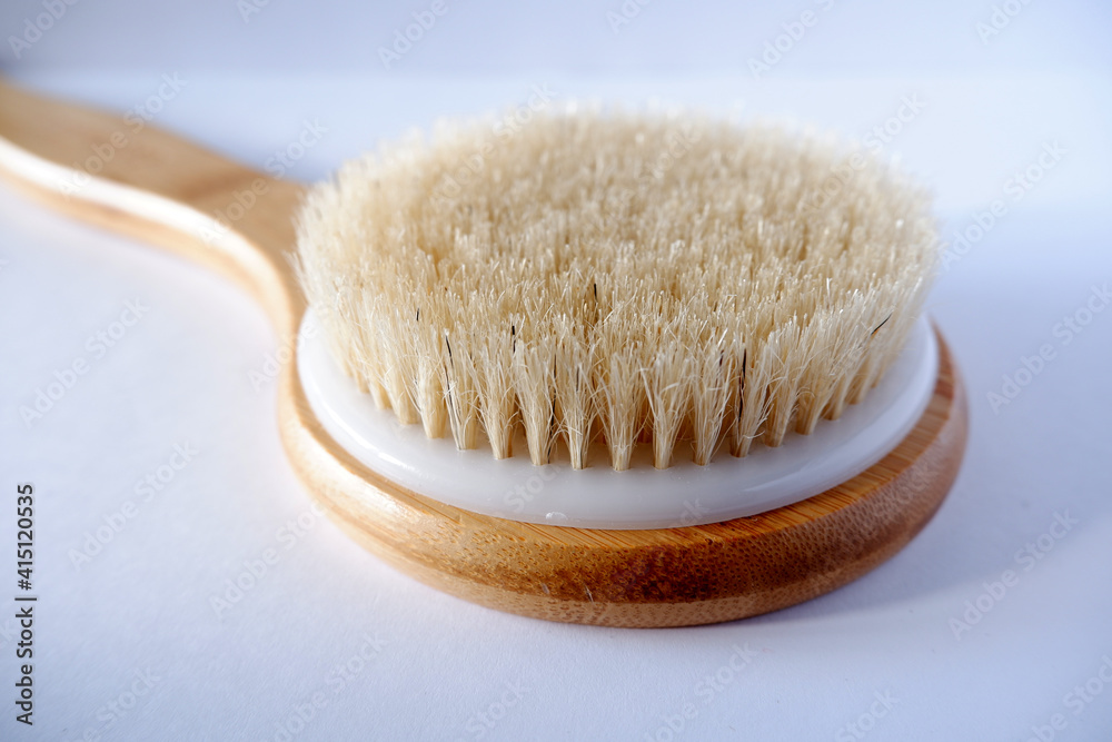 wooden massage brush on white background close wooden massage brush on white background close