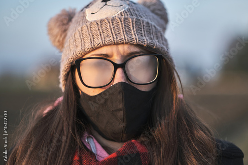 Photos Portrait of a girl with mask and foggy glasses.