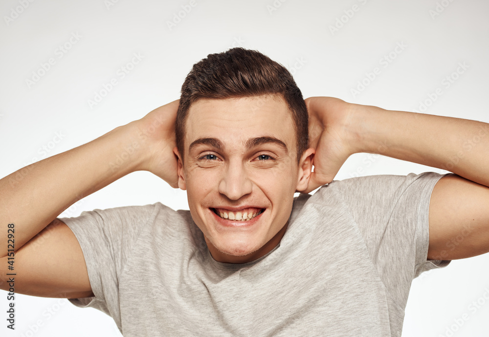 cheerful emotional man gesturing with his hands close-up light background cheerful emotional man gesturing with his hands close-up light background