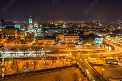 Aerial night view to Holy Dormition Cathedral - Uspenskiy sobor, with embankment of Lopan river and panorama of Kharkiv city, Ukraine