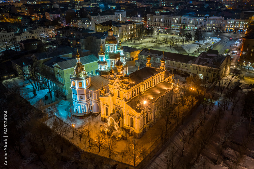 Aerial winter night view to Holy Intercession Monastery - Svyato-Pokrovskyy Cholovichyy Monastyr, with panorama of city in Kharkiv, Ukraine