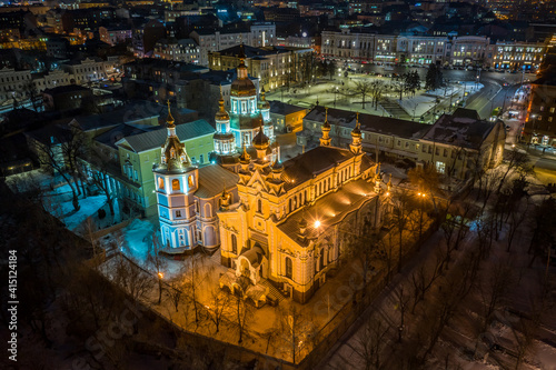 Aerial winter night view to Holy Intercession Monastery - Svyato-Pokrovskyy Cholovichyy Monastyr, with panorama of city in Kharkiv, Ukraine