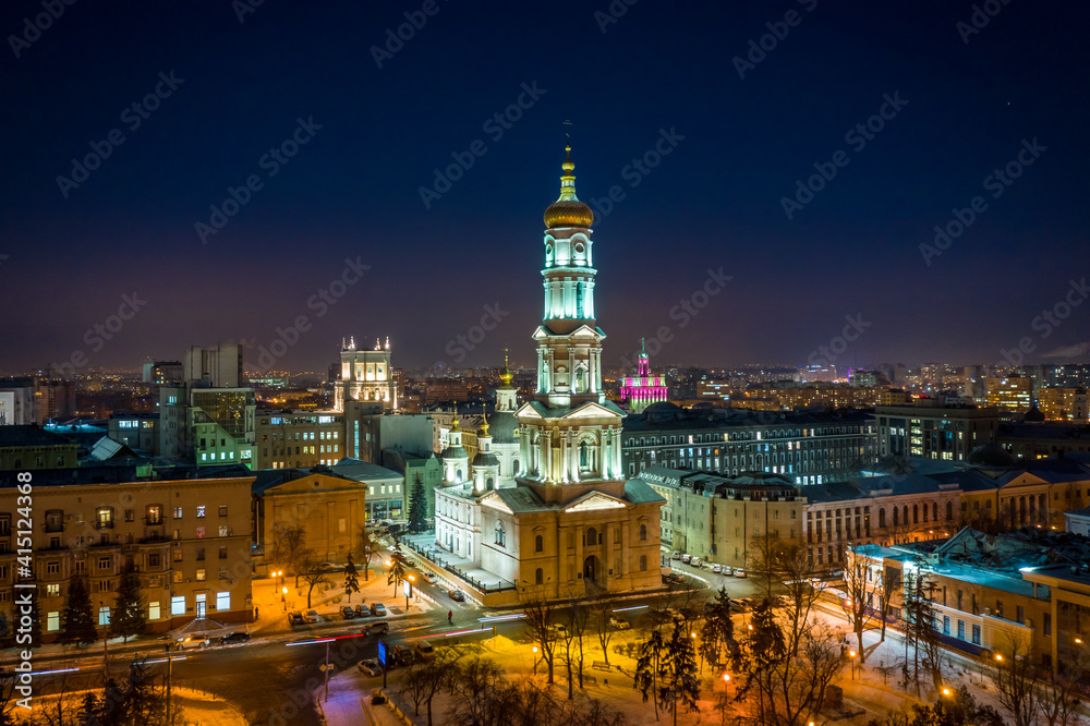 Aerial winter night view to Holy Dormition Cathedral - Uspenskiy sobor, with panorama of city in Kharkiv, Ukraine Aerial winter night view to Holy Dormition Cathedral - Uspenskiy sobor, with panorama of city in Kharkiv, Ukraine