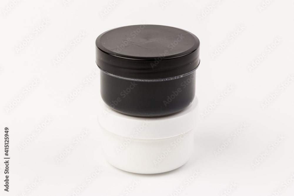 Plastic jars with paint of black and white colors for children's creativity on white background. Paint bottles for art Plastic jars with paint of black and white colors for children's creativity on white background. Paint bottles for art