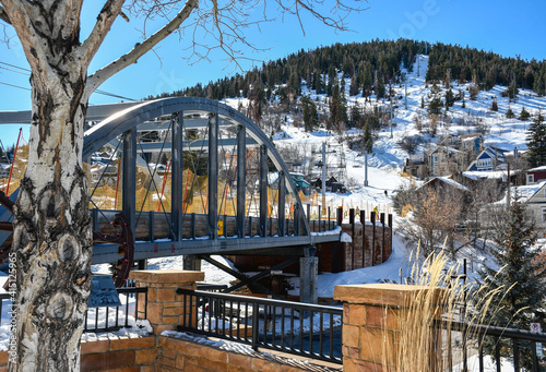 Bridge along ski run in downtown Park City area with vacation homes in the Utah mountains during winter