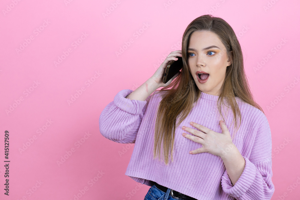 Young pretty woman with long hair standing over isolated pink background talking on the phone with a worried expression Young pretty woman with long hair standing over isolated pink background talking on the phone with a worried expression