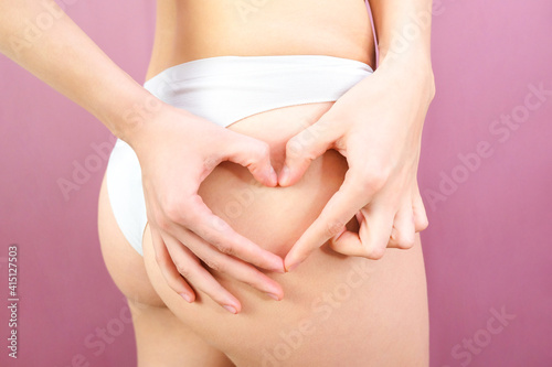 Wallpaper Mural hands in the shape of a heart on the background of the buttocks of a young woman. Torontodigital.ca