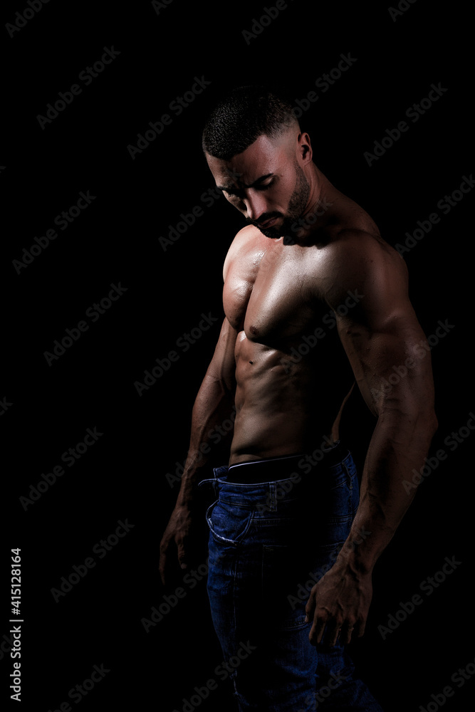 El cuerpo masculino perfecto - Impresionante culturista posando. Chico joven musculado. Aislado sobre fondo negro. Espacio para texto