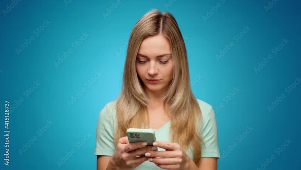 Young woman using her smartphone in studio Young woman using her smartphone in studio
