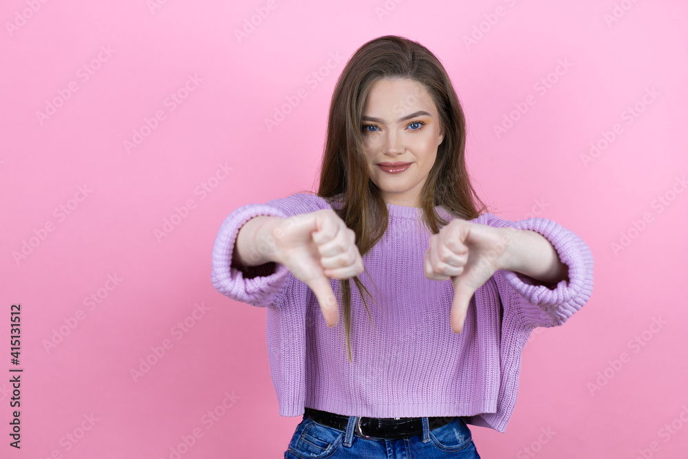 Φωτογραφία Young pretty woman with long hair standing over isolated pink background with an