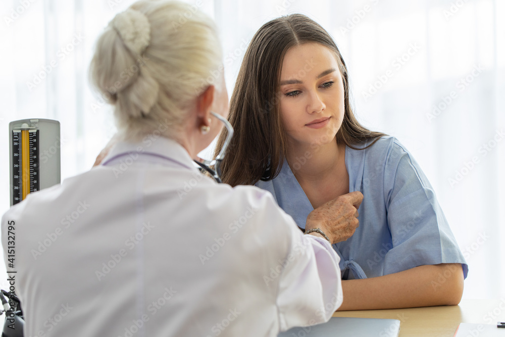 Doctor uses stethoscope to check heart beat of young and cute patient Doctor uses stethoscope to check heart beat of young and cute patient