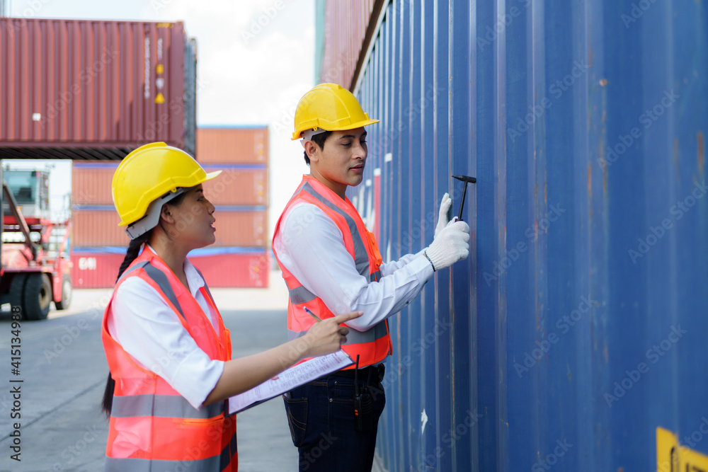 Asian engineer or Foreman using Chipping Hammer tool for checking the container after the repair complete to prepare the delivery to the customer. Asian engineer or Foreman using Chipping Hammer tool for checking the container after the repair complete to prepare the delivery to the customer.