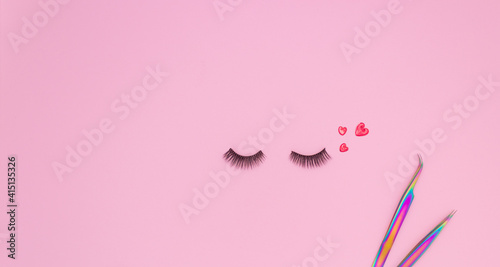 Tools and patches for eyelash extensions and artificial eyelashes on a pink background. Tools for the lashmaker. The view from the top.