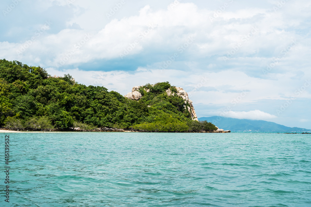 Tropical island with a palm trees with a crystal clear blue sea water and cloudy sky. Tropical island with a palm trees with a crystal clear blue sea water and cloudy sky.