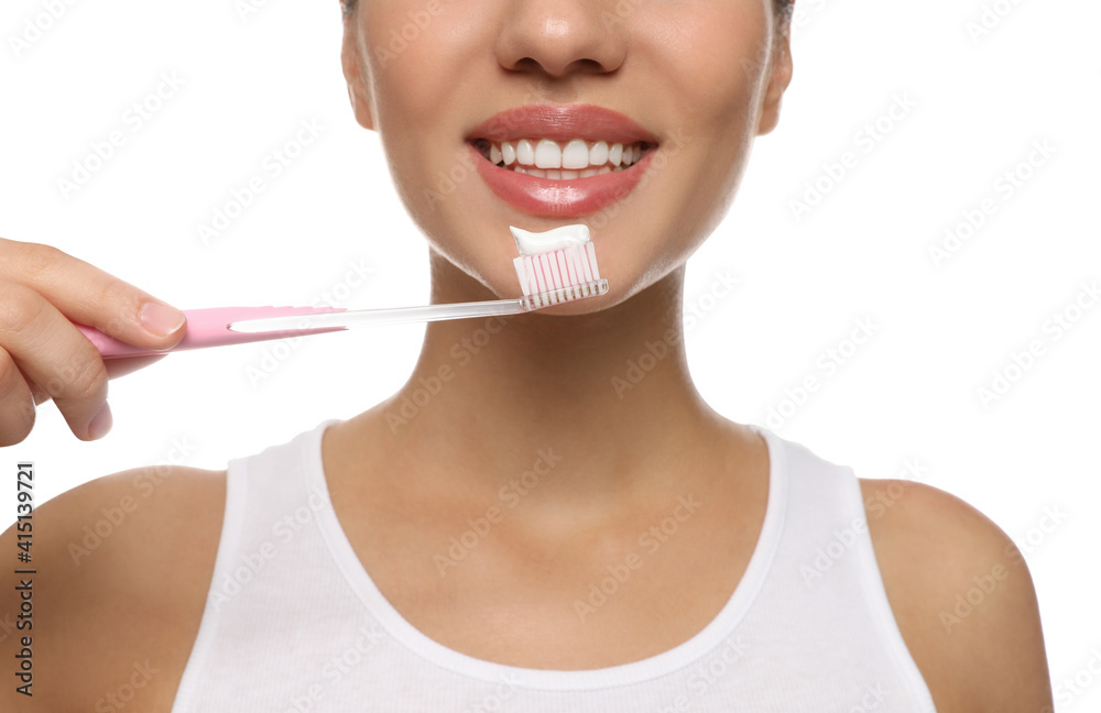 Woman holding toothbrush with paste on white background, closeup Woman holding toothbrush with paste on white background, closeup