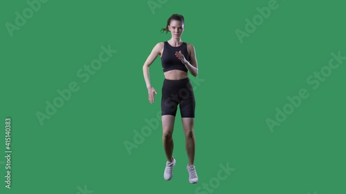 Aerobic woman doing side shuffle legs exercise in slow motion. Full body on chroma key green screen.  photo