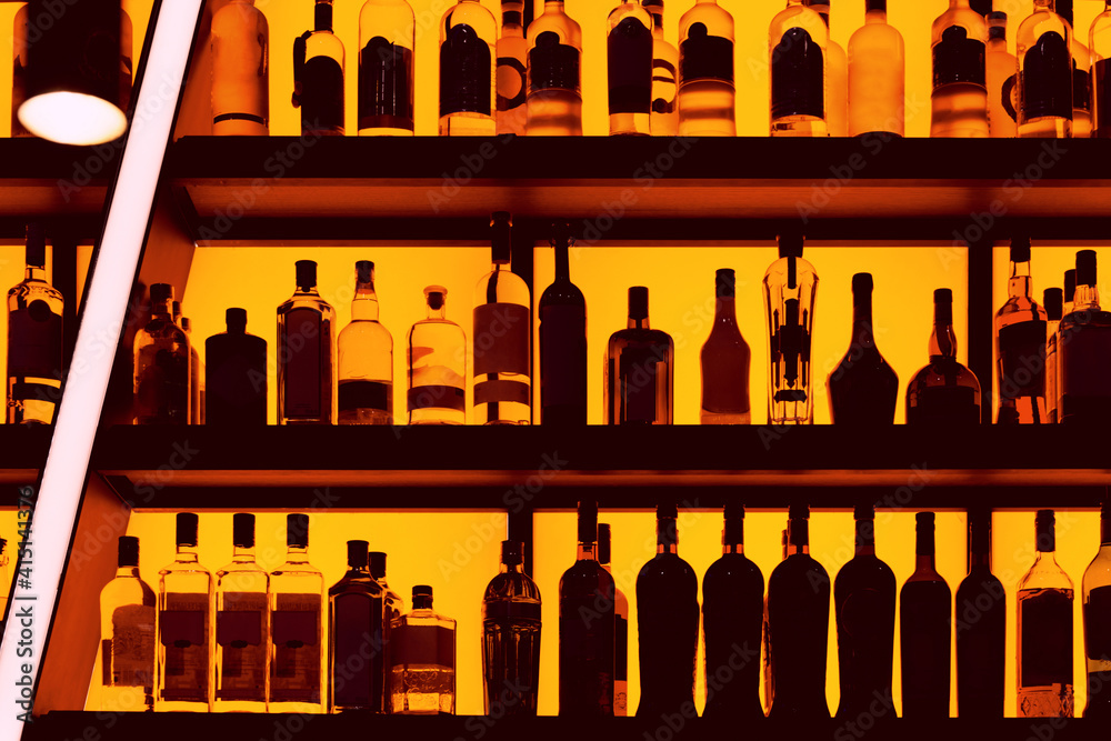 Bottles sitting on shelf in a bar Bottles sitting on shelf in a bar