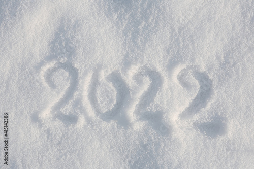 2022 written on white snow, top view