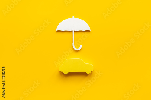 Buy car insurance concept. Car shape under umbrella