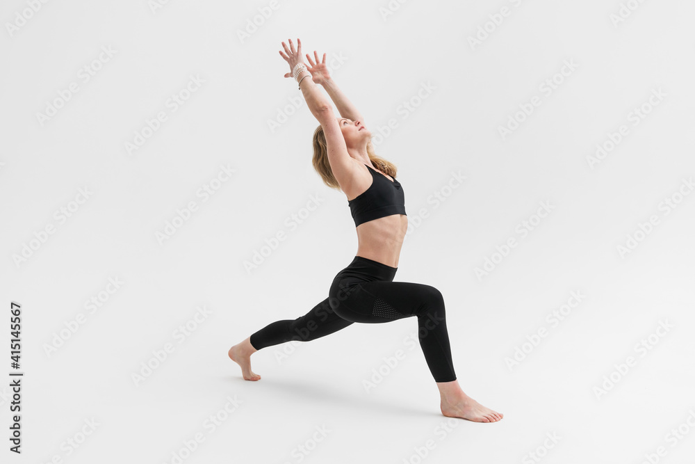 Sporty blonde woman exercising yoga on white background