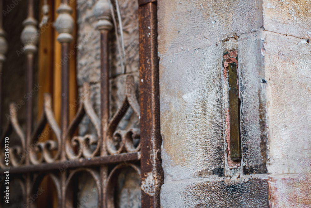 Mezuzah built into the wall at the corner of the stone passage to the inside. Metal gates on the passage to the courtyard. Jewish symbols (252) Mezuzah built into the wall at the corner of the stone passage to the inside. Metal gates on the passage to the courtyard. Jewish symbols (252)