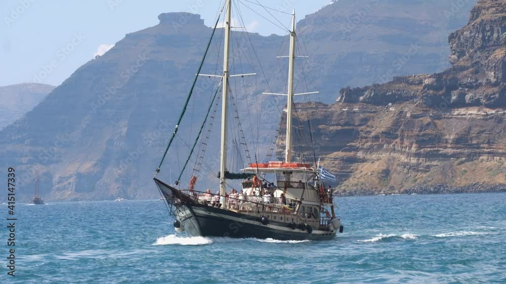 Oia, Santorini, Greece - 25 May, 2019: Old wooden Sailing ship tourist tour to the Santorini Volcano Oia, Santorini, Greece - 25 May, 2019: Old wooden Sailing ship tourist tour to the Santorini Volcano