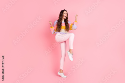 Full length body size view of attractive overjoyed cheerful girl celebrating having fun triumph isolated over pink pastel color background
