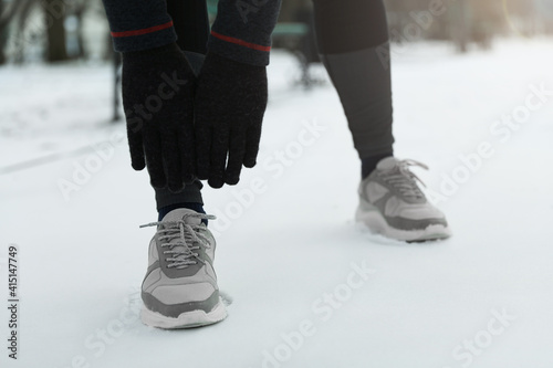 Man doing sports exercises in winter park, closeup