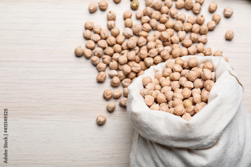 Sack with chickpeas on wooden table, flat lay. Space for text Sack with chickpeas on wooden table, flat lay. Space for text