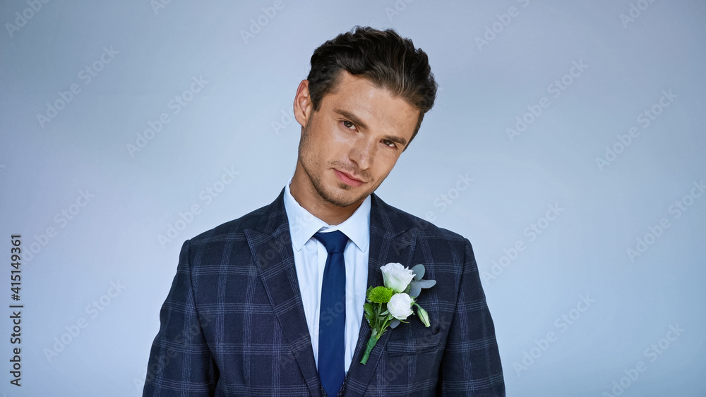 young elegant bridegroom smiling at camera isolated on blue young elegant bridegroom smiling at camera isolated on blue