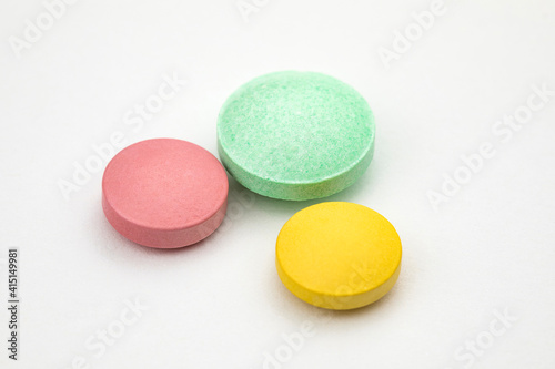 Multicolored tablets on white background. Health care concept.