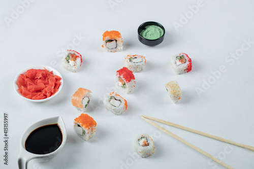 Variety of sushi rolls served with wasabi and soy sauce
