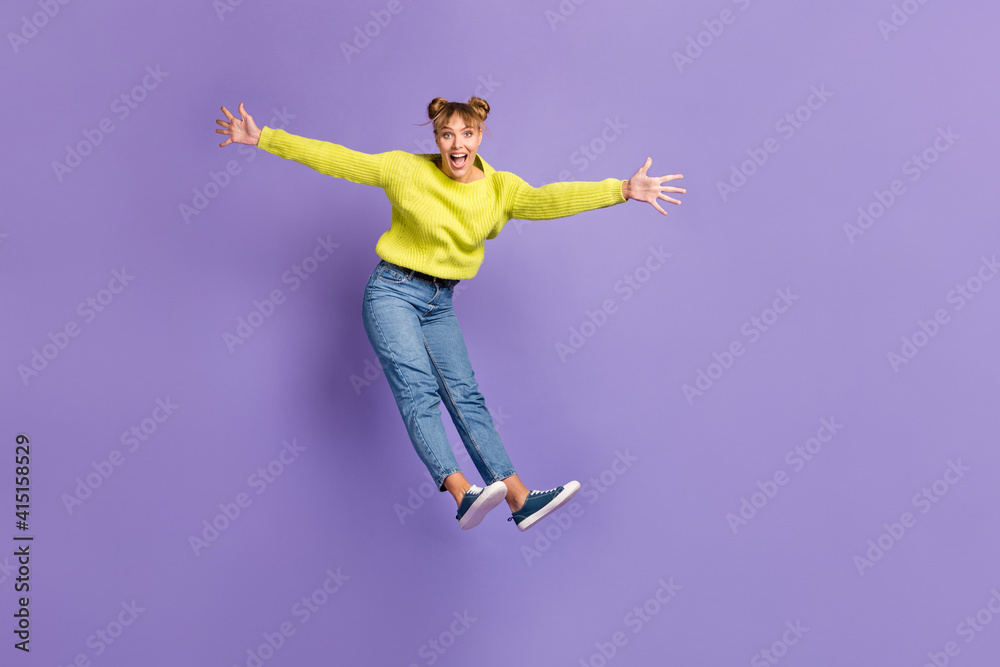 Full length body size view of pretty cheerful girl jumping having fun enjoying freedom good mood isolated on bright violet color background