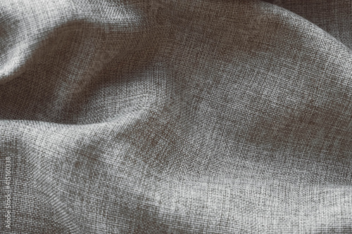 Crumpled gray linen fabric as background texture. Top view. Copy, empty space for text photo